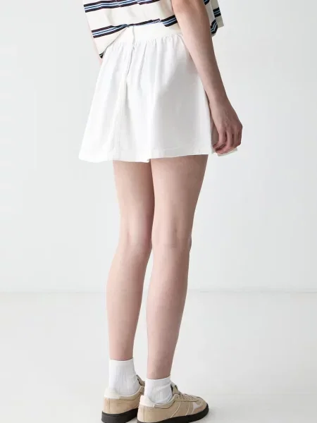 Rozkloszowana spódnica mini z czystej bawełny Tommy Jeans beżowa