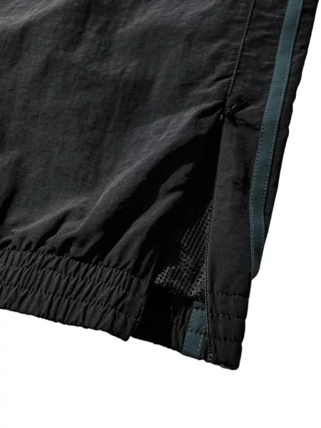 Бягане панталон Martine Rose на райета черно