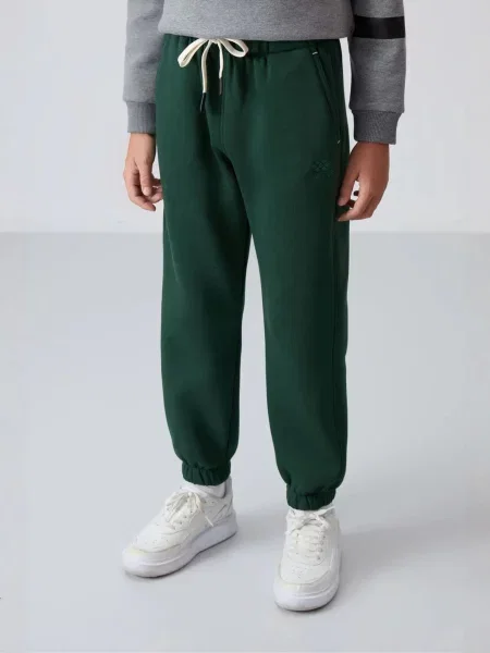 Tommy Life Kalhoty TOMMY Kinder Jogginghose tmavě zelená