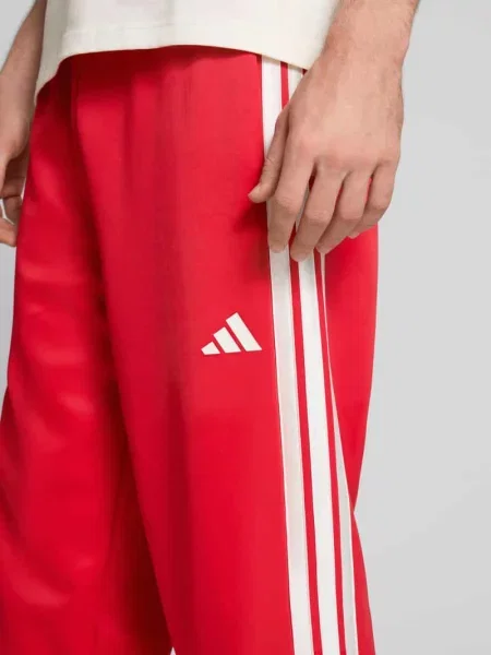 Spodnie dresowe z logo i elastycznym pasem Adidas Sportswear czerwony